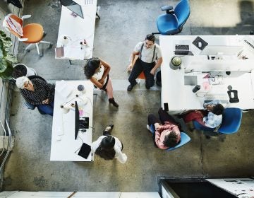 Overhead view of design team having project meeting in office