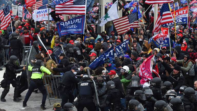 Rioters clash with police as they push barricades to storm the U.S. Capitol on Jan. 6, 2021. Rioters clash with police as they push barricades to storm the U.S. Capitol on Jan. 6, 2021. (Roberto Schmidt/AFP via Getty Images)