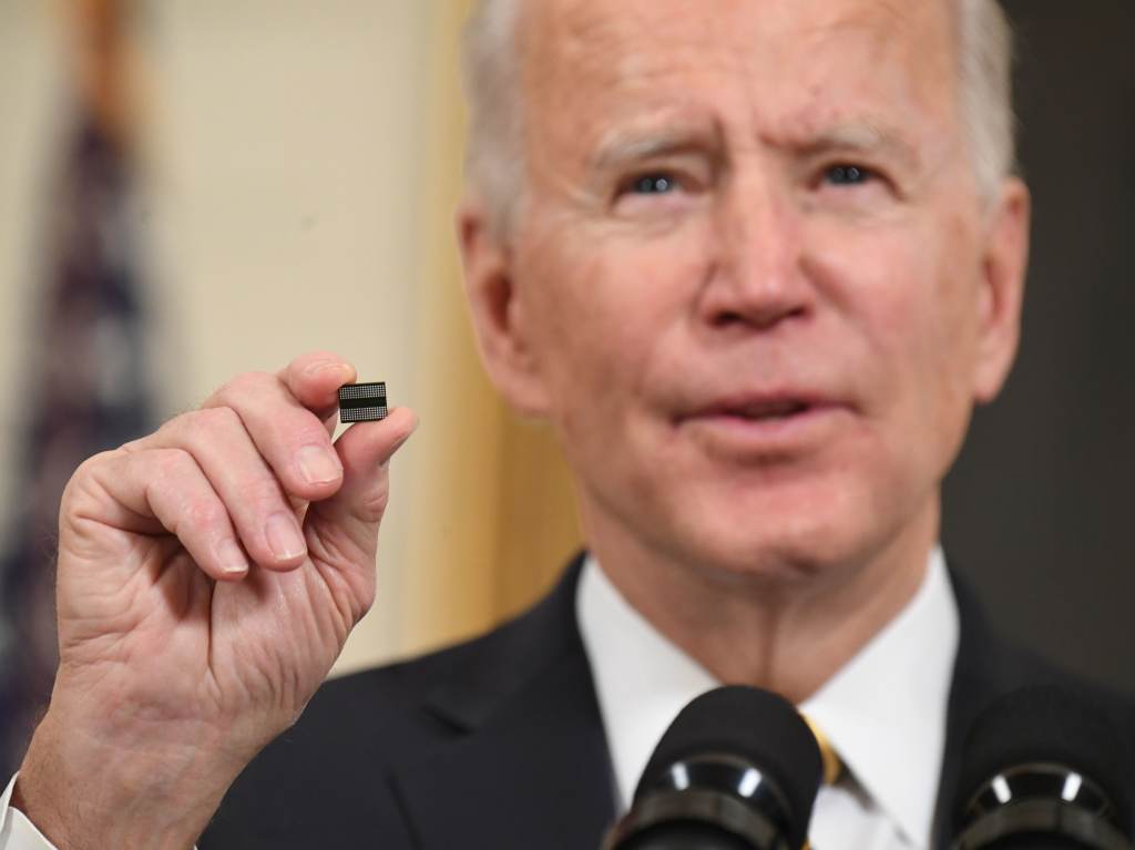 Joe Biden holds a microchip as he speaks