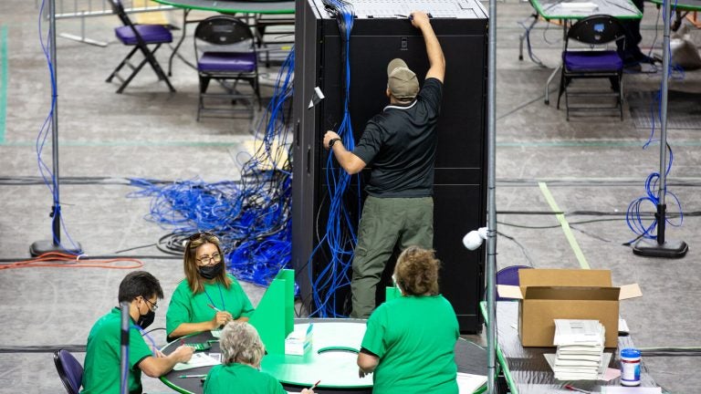 Contractors examine and recount ballots from the 2020 general election