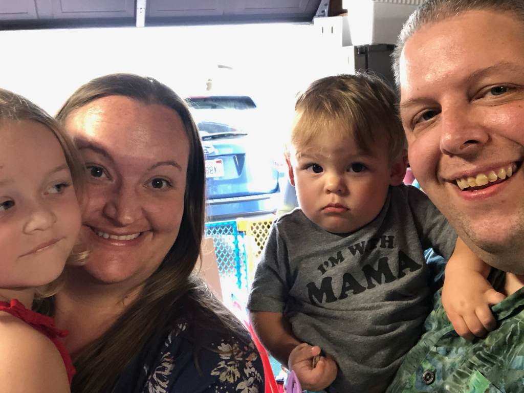 Jeremy smiles for a photo with his wife Cecelia and their children, Michaela and Alexander