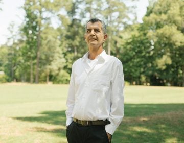 Mehran Mossaddad stands in a park