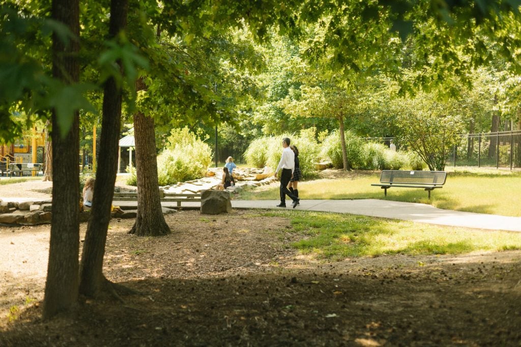 Mehran Mossaddad and his daughter walk through a park