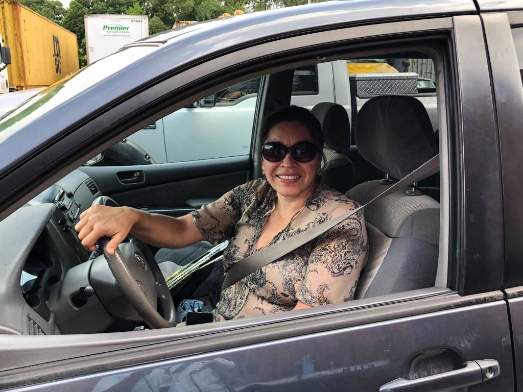 Estrella Sanchez sits inside her car