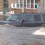 Aa car is pictured in heavy floodwaters