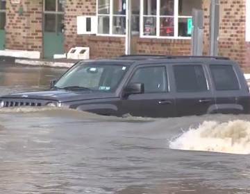 Aa car is pictured in heavy floodwaters