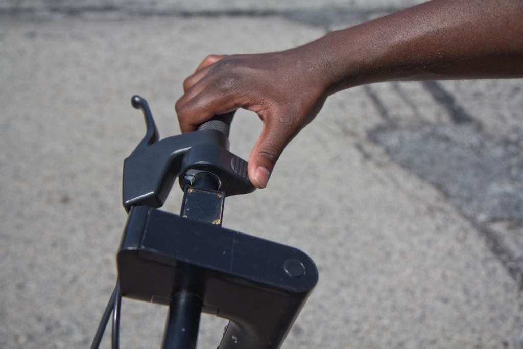 A closeup of a person's hand on a Verve S pedal bike handle