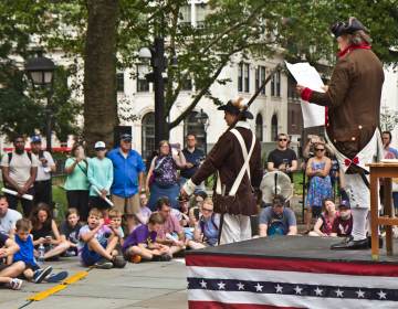 Actors perform a reading of the Declaration of Independence at Independence Hall as spectators watch