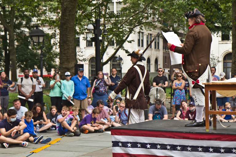 Actors perform a reading of the Declaration of Independence at Independence Hall as spectators watch