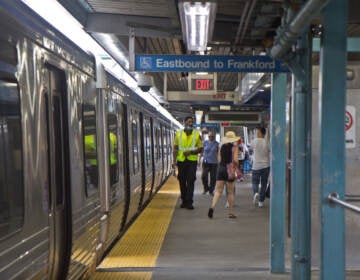 A transit security officer works on the platform of the Girard stop