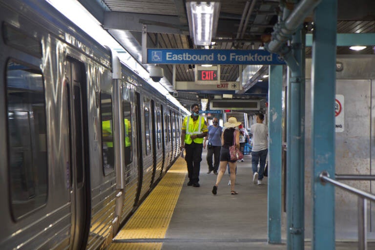 A transit security officer works on the platform of the Girard stop