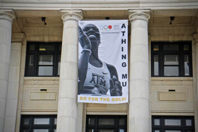 A banner celebrating Olympic track star Athing Mu hands on the front of Trenton City Hall.