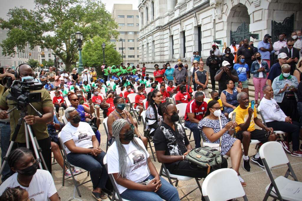 A crowd gathers on the steps of Trenton City Hall