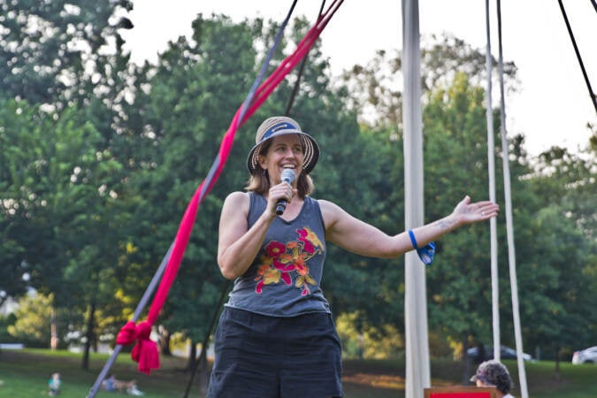 Kittson O’Neill speaks into a microphone during a Shakespeare in Clark Park event