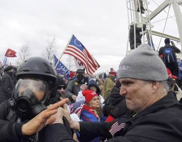In this Jan. 6, 2021, image from video, Alan William Byerly, right, is seen allegedly attacking an Associated Press photographer during a riot at the U.S. Capitol in Washington. Byerly has been arrested on charges that he assaulted an Associated Press photographer and police officers. (AP Photo/Julio Cortez)