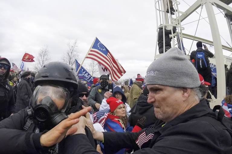 In this Jan. 6, 2021, image from video, Alan William Byerly, right, is seen allegedly attacking an Associated Press photographer during a riot at the U.S. Capitol in Washington. Byerly has been arrested on charges that he assaulted an Associated Press photographer and police officers. (AP Photo/Julio Cortez)