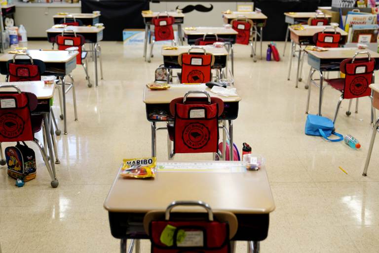 Desks are spaced apart in a classroom