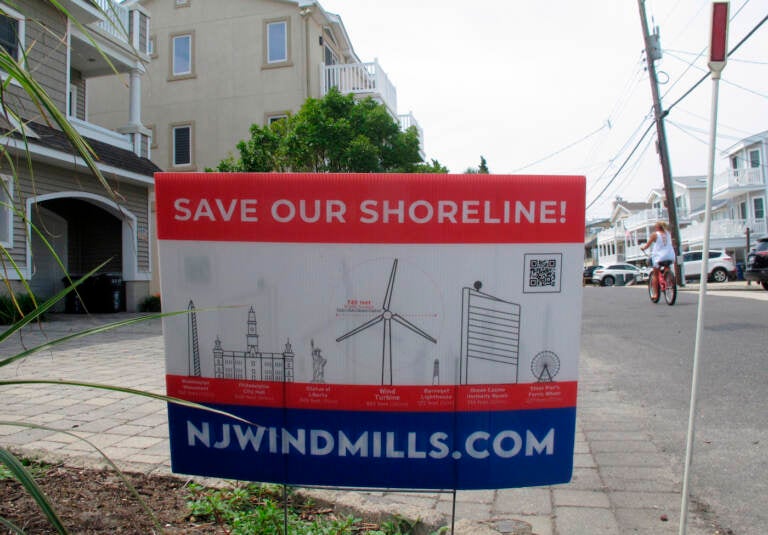 This July 8, 2021 photo shows a sign in Ocean City, N.J. urging opposition to offshore wind projects. (AP Photo/Wayne Parry)
