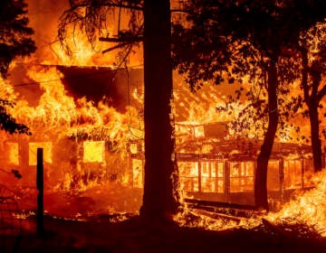 Flames from the Dixie Fire consume a home in the Indian Falls community