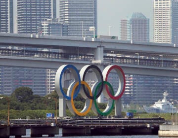 The Olympic rings float on a barge ahead of the 2020 Summer Olympics