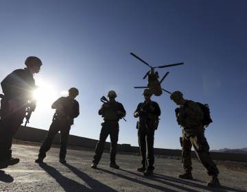 FILE - In this Nov. 30, 2017, file photo, American soldiers wait on the tarmac in Logar province, Afghanistan. (AP Photo/Rahmat Gul, File)