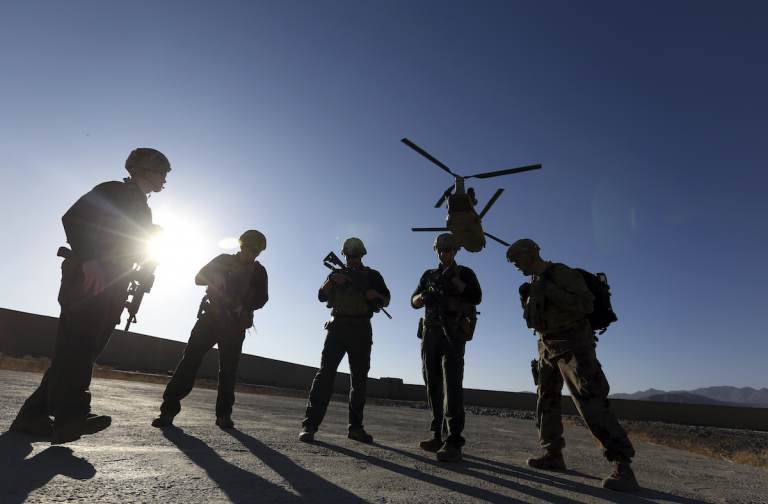 FILE - In this Nov. 30, 2017, file photo, American soldiers wait on the tarmac in Logar province, Afghanistan. (AP Photo/Rahmat Gul, File)