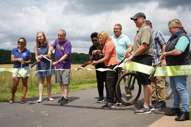 Burlington County officials and representatives from partnering organizations cut the ribbon on the new Delaware River Heritage Trail Bypass 130. (Kenny Cooper/WHYY)