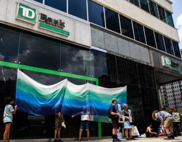Protesters with the Philly Water Protectors gathered at 15th and JFK Boulevard outside TD Bank to rally against the Line 3 tar sands pipeline in Minnesota, which is being financed by TD, on July 16, 2021. (Kimberly Paynter/WHYY)