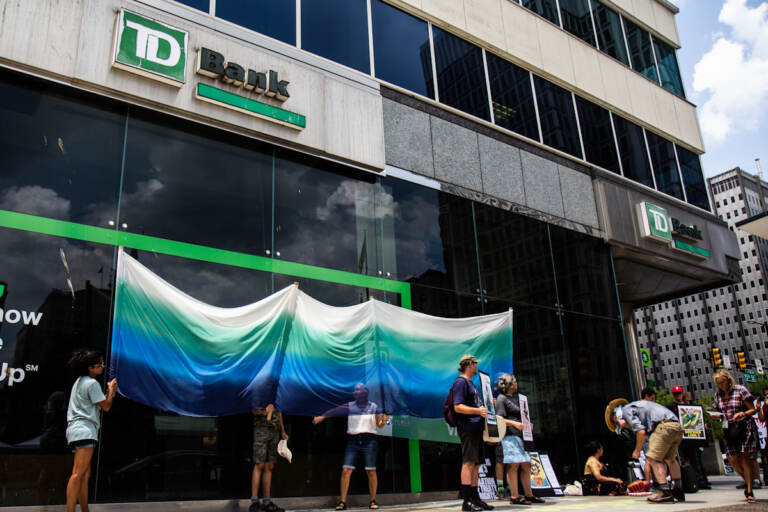 Protesters with the Philly Water Protectors gathered at 15th and JFK Boulevard outside TD Bank to rally against the Line 3 tar sands pipeline in Minnesota, which is being financed by TD, on July 16, 2021. (Kimberly Paynter/WHYY)