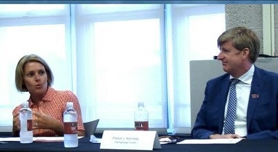 Amy Kennedy and Patrick Kennedy sit at a conference table