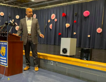 School District of Philadelphia Chief Operating Officer Reggie McNeil points to the district’s new air and surface purifiers. Thursday’s announcement was made at Juniata Park Academy in the lower Northeast. (Johann Calhoun / Chalkbeat)