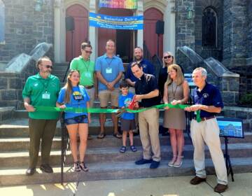 Solarize Delco's ribbon cutting. Left to Right:
Peter Puglionesi, Melisa Romano, and Noel Smyth of Solarize Delco; Mike Zabel State Representative; Pastor Tim Johansen with son Leo; Colin Quinn VP Haverford Board of Commissioners; Francine Locke Del. Co. Director of Sustainability; Elaine Schaefer Del. Co. Council, Gerald Hart President Haverford Board of Commissioners. (Courtesy of Delaware County/Adrienne Marofsky)