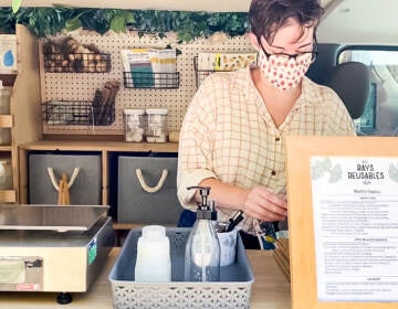 A cashier working at Ray's Reusables, a mobile unit that sells local goods