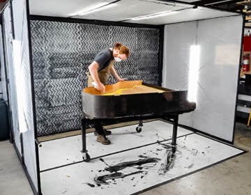 A man restoring a piano