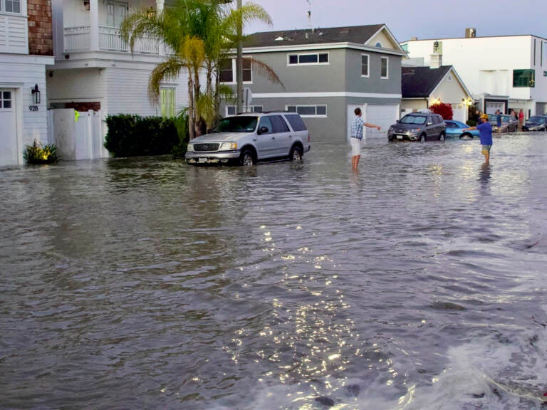 Streets and homes flooded in Newport Beach, Calif., during a high tide in July 2020. So-called sunny day floods are getting more common in coastal cities and towns as sea levels rise due to climate change. (Matt Hartman/AP)