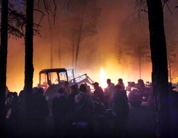 Volunteers prepare to douse a forest fire in the republic of Sakha