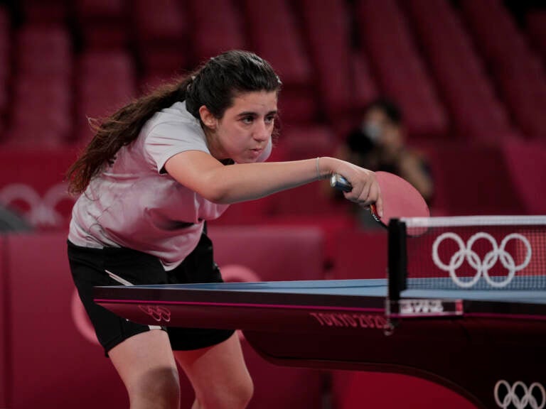 Syria's Hend Zaza competes during women's table tennis singles preliminary round match against Austria's Liu Jia at the 2020 Summer Olympics in Tokyo. (Kin Cheung/AP)