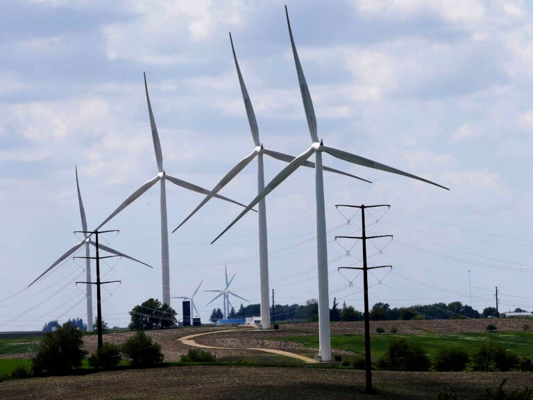 Wind turbines in a field in Adair, Iowa. Democrats' budget deal would use financial carrots and sticks to encourage utilities to shift to clean energy. (Charlie Neibergall/AP)