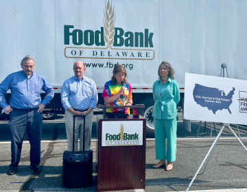 Hunger Free America CEO Joel Berg (left) joins U.S. Sen. Chris Coons, Food Bank of Delaware president Cathy Kanefsky and Delaware Congresswoman Lisa Blunt Rochester at a food distribution event in Georgetown Tuesday morning. (Johnny Perez-Gonzalez / WHYY)