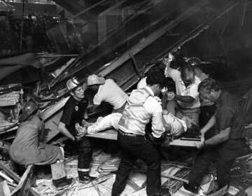 Firefighters rescue people from under a collapsed walkway in the lobby of the Hyatt Regency Hotel in Kansas City, Mo., on July 17, 1981. The collapse killed 114 people and injured more than 200. (Bettmann Archive/Getty Images)