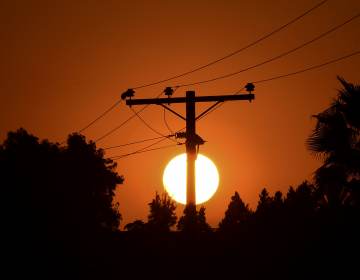 The sun sets behind power lines in Los Angeles in September.
(Frederic J. Brown/AFP via Getty Images)
