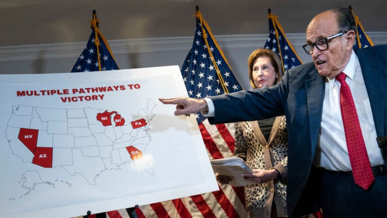 Rudy Giuliani points to a map as he speaks to the press about various lawsuits related to the 2020 election on Nov. 19, 2020. He and other Trump lawyers are now under scrutiny for their roles in promoting false claims of election fraud. (Drew Angerer/Getty Images)