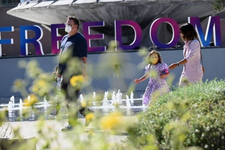 People enjoy an outdoor art exhibition