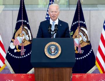 Biden speaks from a podium with American flags behind him at the National Constitution Center