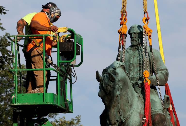 Workers remove a statue of Confederate Gen. Robert E. Lee from Market Street Park on Saturday in Charlottesville, Va. (Win McNamee/Getty Images)