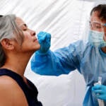 A medical assistant administers a COVID-19 test