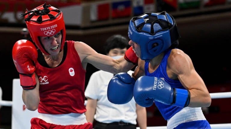 Mandy Bujold (L) of Canada exchanges punches with Nina Radovanovic of Serbia