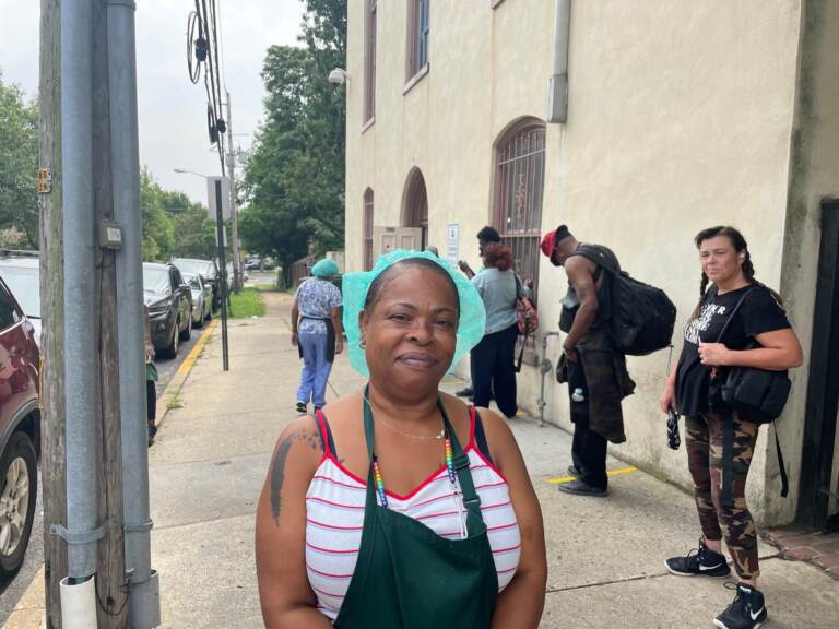 Joanne Matthews of the Emmanuel Dining Room exhorted people in line to get the shot. (Cris Barrish/WHYY)