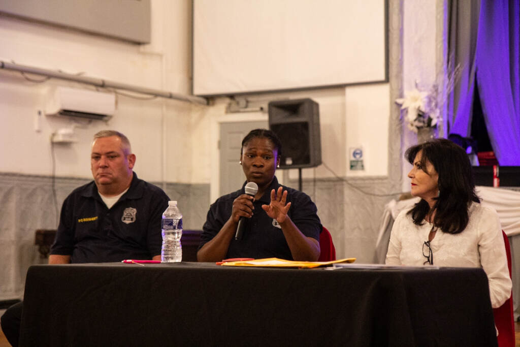 Caroline Turner, Hickinson, and Dougherty sit at a table at an event