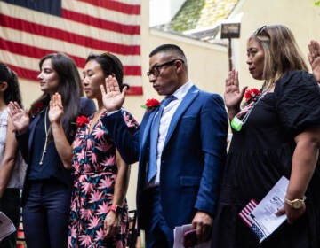 People participate in a naturalization ceremony at the Betsy Ross House